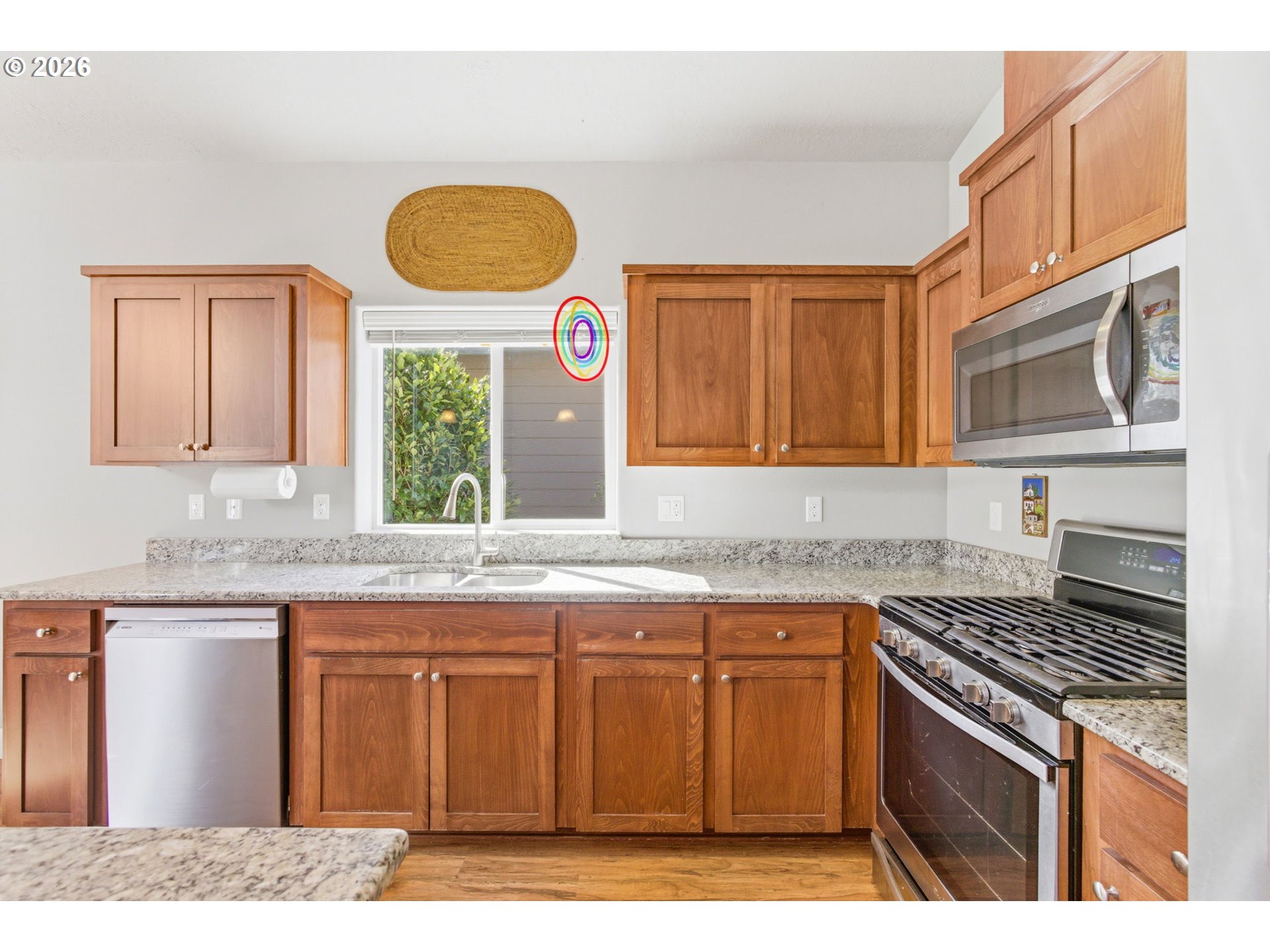 2418 Equestrian Loop South Salem, OR 97302 - Photo 15 of 39 a kitchen with stainless steel appliances granite countertop a stove a sink and a microwave