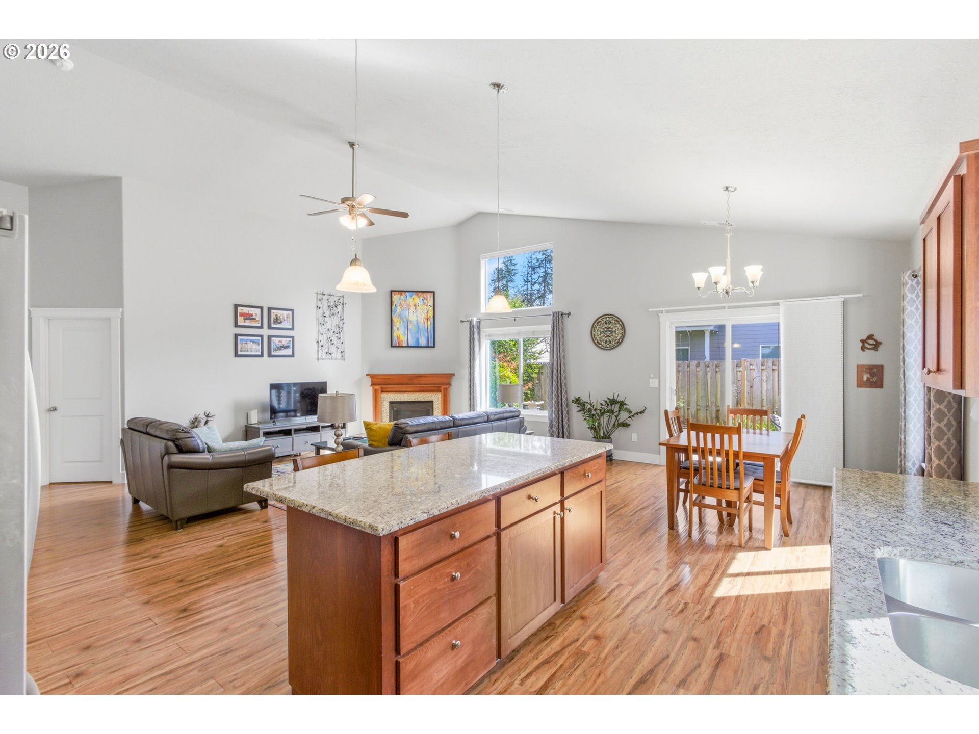 2418 Equestrian Loop South Salem, OR 97302 - Photo 17 of 39 a living room with granite countertop furniture a dining table wooden floor and a fireplace