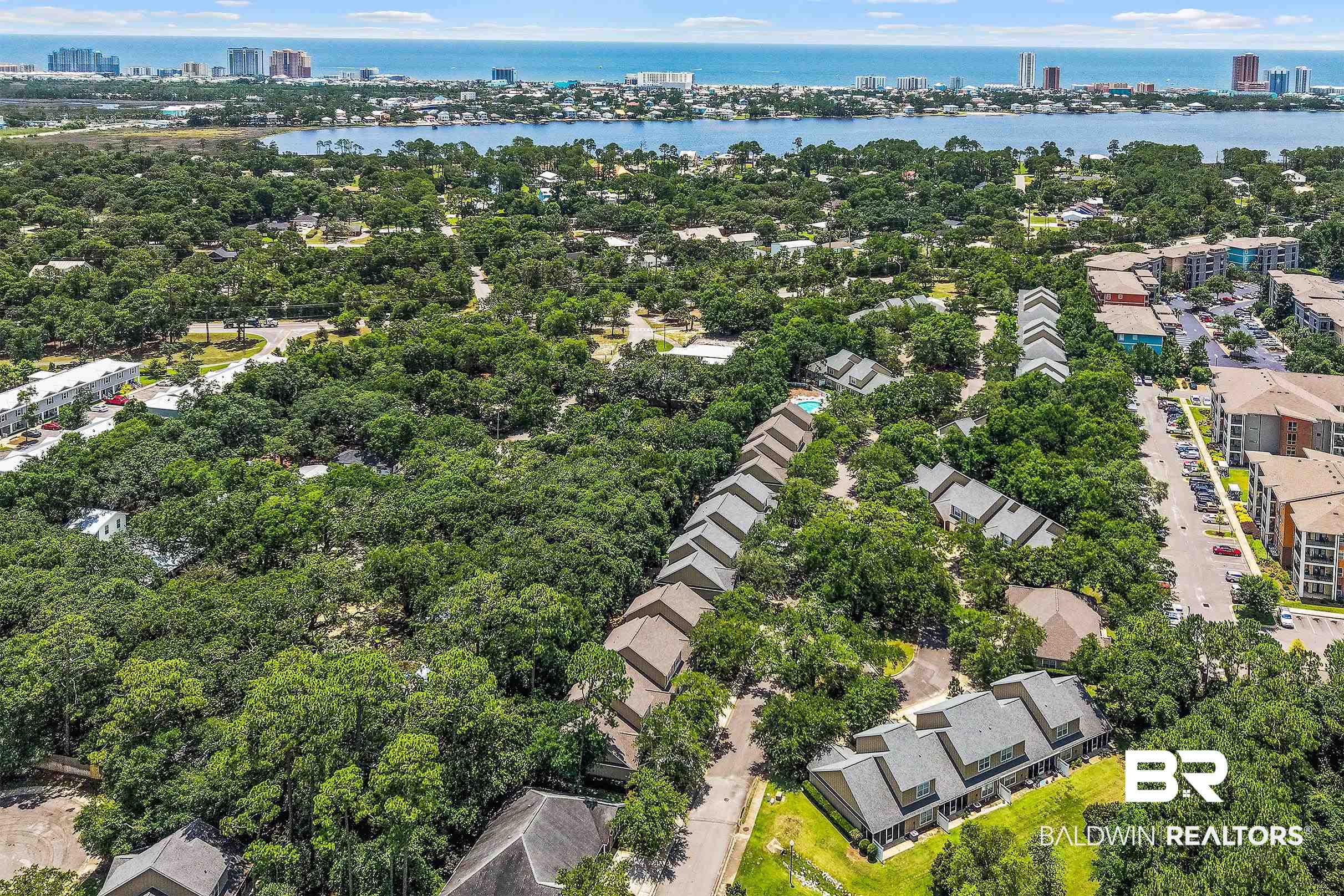 430 West Fort Morgan Road, Unit 704 Gulf Shores, AL 36542 - Photo 32 of 35 Aerial perspective showcasing a residential area with townhomes and apartment buildings