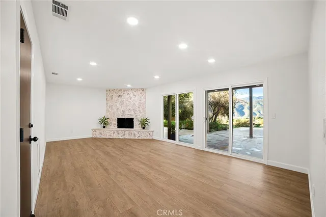 a large kitchen with stainless steel appliances kitchen island a large counter top and a wooden floors