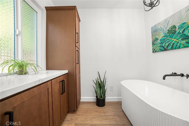 a bathroom with a toilet a sink a shower a mirror and vanity