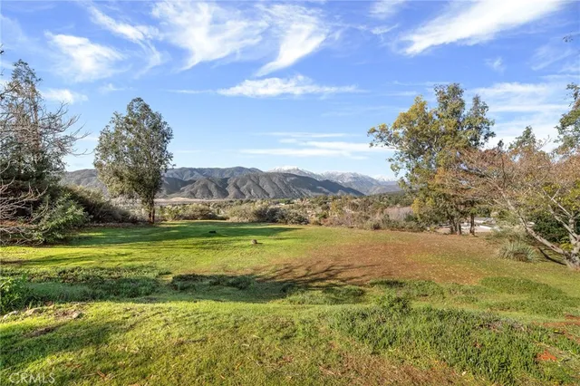 a house view with swimming pool and yard in the back