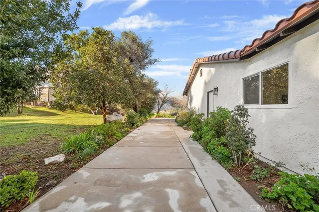 a front view of a house with a lot of flowers