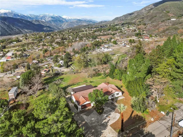 an aerial view of a house with yard