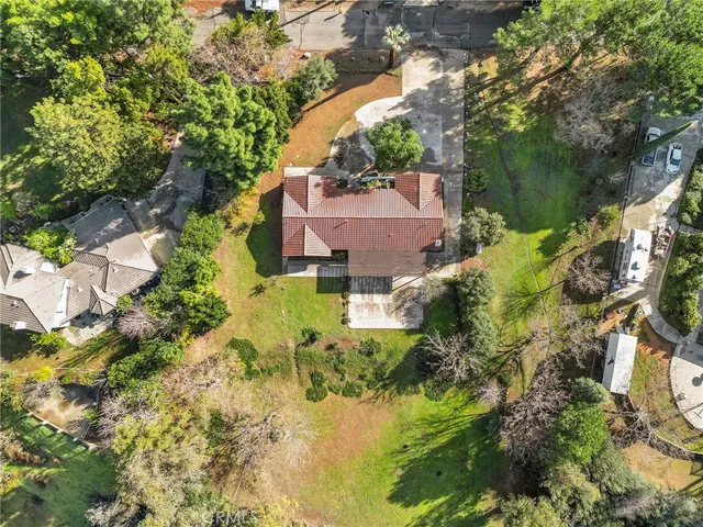 an aerial view of residential building with parking and yard