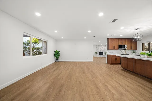 a large kitchen with a lot of counter space and a wooden floor