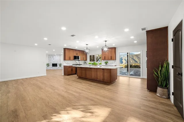 a large kitchen with stainless steel appliances granite countertop a large counter top and a stove