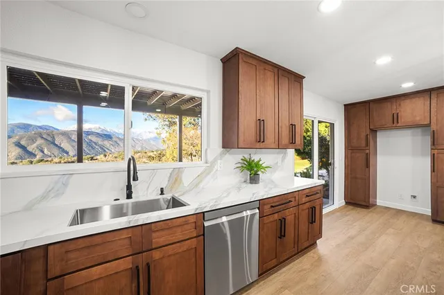 a large kitchen with kitchen island a large counter space wooden floor and stainless steel appliances