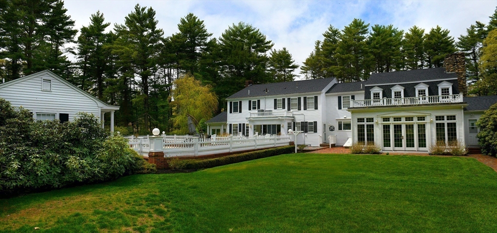 28 Pineswamp Road Ipswich, MA 01938 - Photo 5 of 42 a front view of a house with a garden and trees