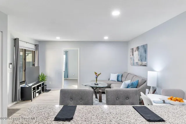 a living room with furniture wooden floor and a rug