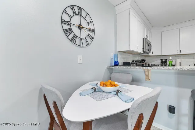 a kitchen with a table chairs a sink and a stove