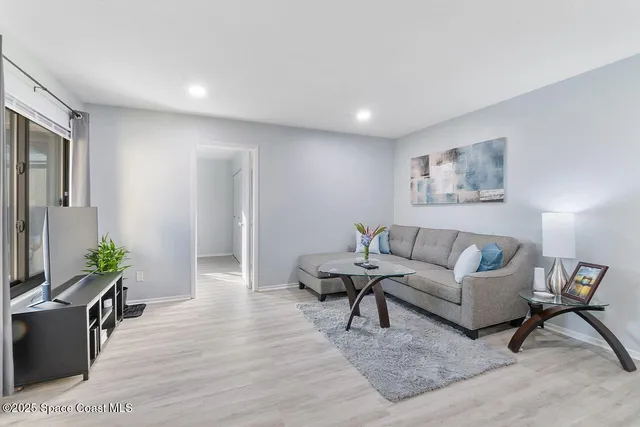 a living room with furniture and a potted plant