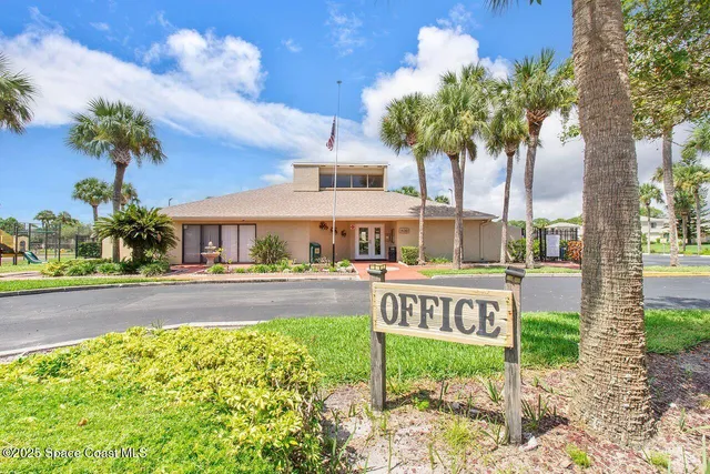 a house with palm trees in front of it
