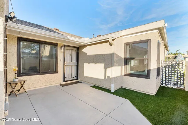 a view of a porch with a table and chairs