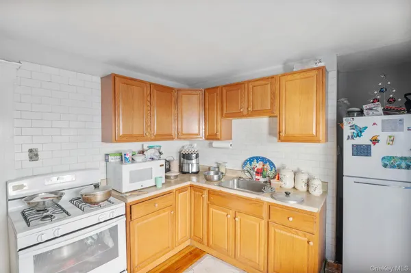 a kitchen with a window a sink and a dining table