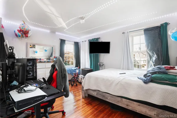 a bedroom with a bed and flat screen tv