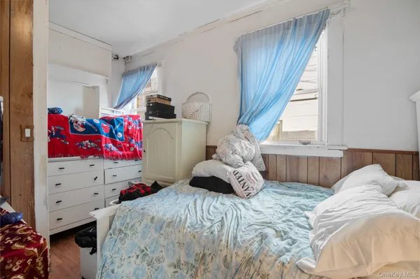 a bed sitting in a bedroom next to a window