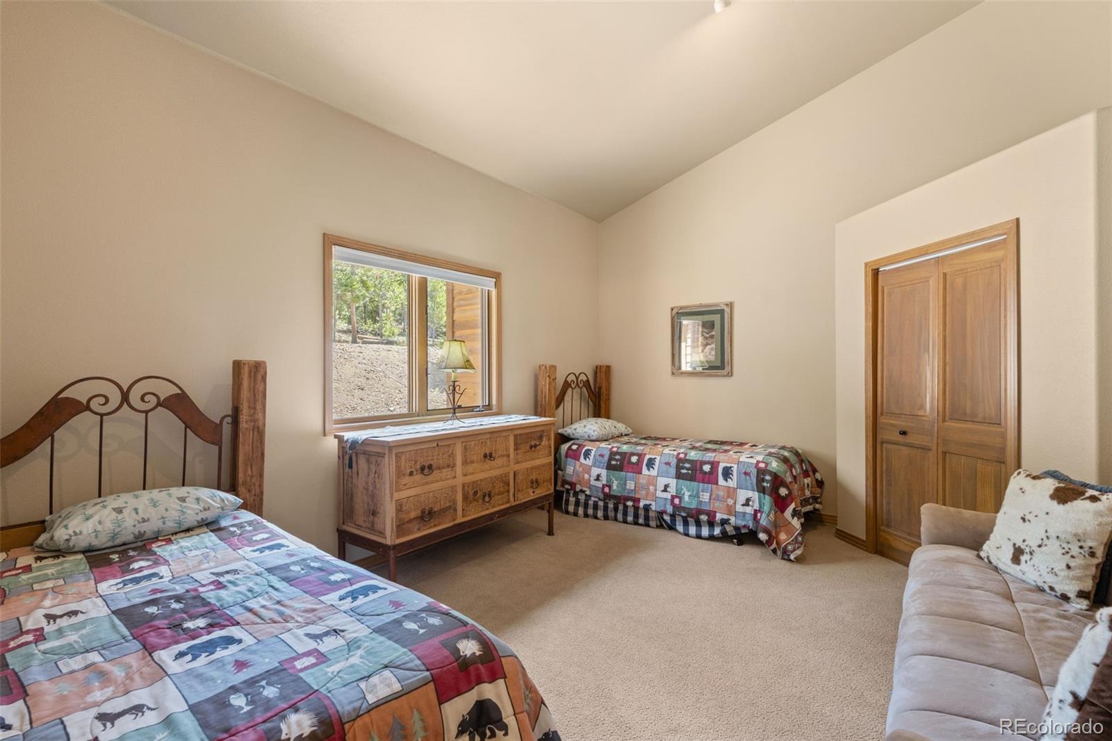 92 Emmett Lode Road, Unit B Breckenridge, CO 80424 - Photo 24 of 50 a bedroom with a bed and a dresser