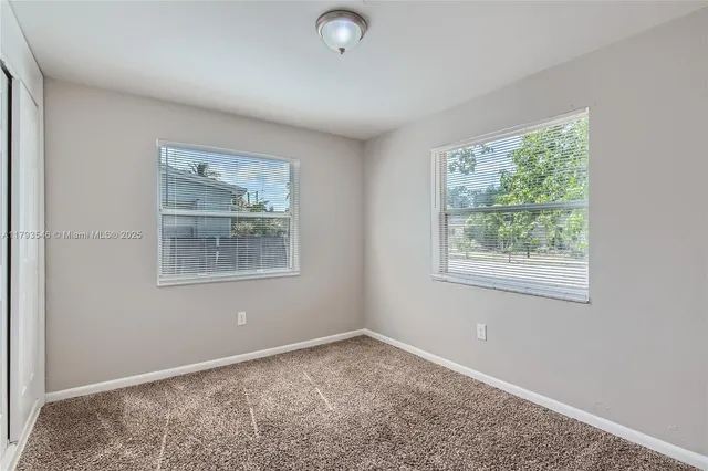 a bathroom with a granite countertop sink mirror bathtub and shower