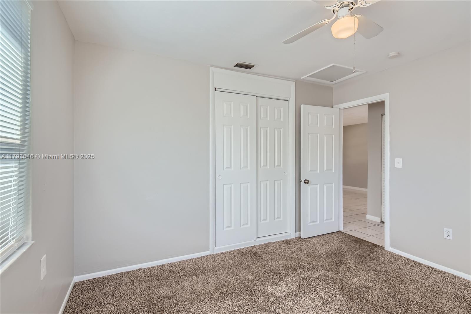 6437 Custer Street Hollywood, FL 33024 - Photo 16 of 22 an empty room with closet and a chandelier fan