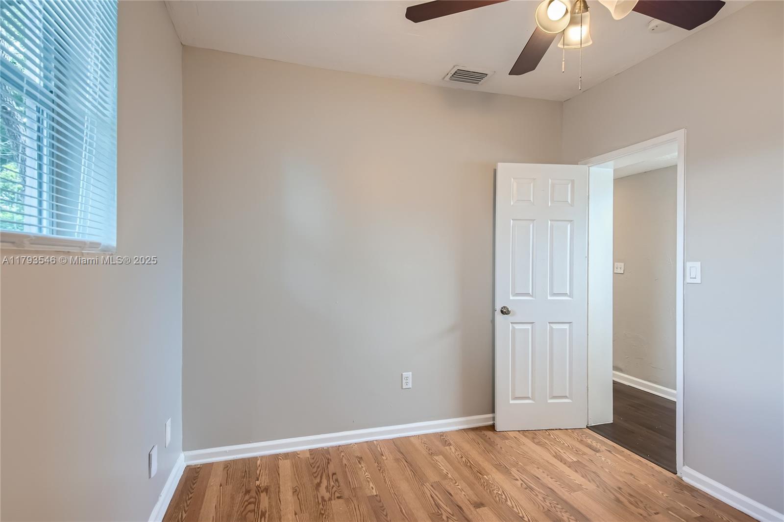 6437 Custer Street Hollywood, FL 33024 - Photo 17 of 22 an empty room with a ceiling fan and window