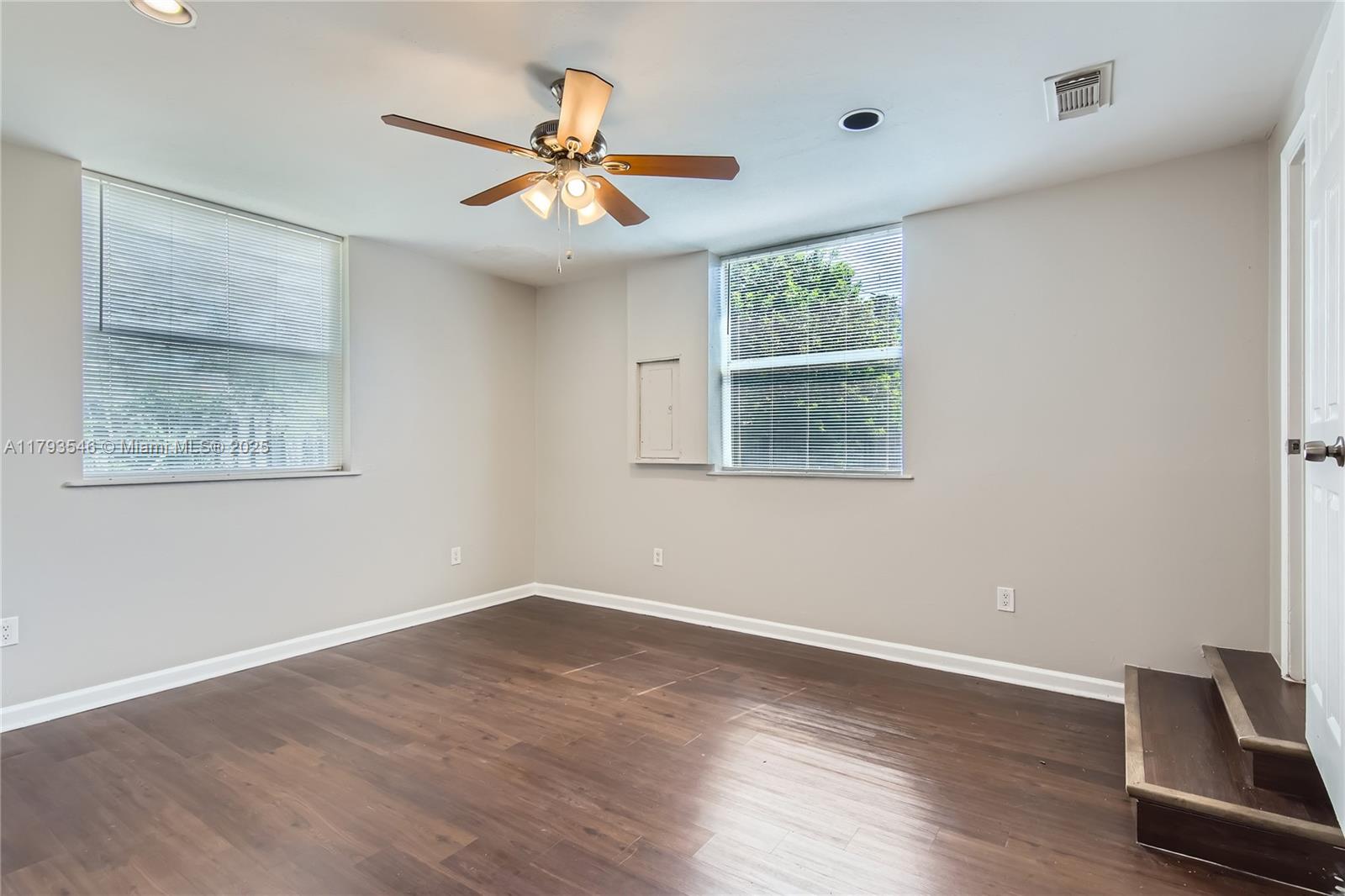 6437 Custer Street Hollywood, FL 33024 - Photo 20 of 22 a view of wooden floor and a chandelier fan in a room