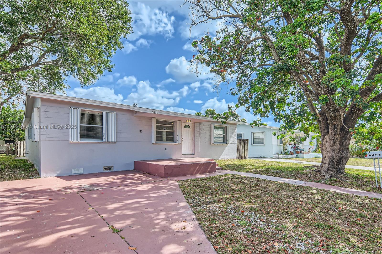 6437 Custer Street Hollywood, FL 33024 - Photo 2 of 22 a front view of a house with a yard and garage