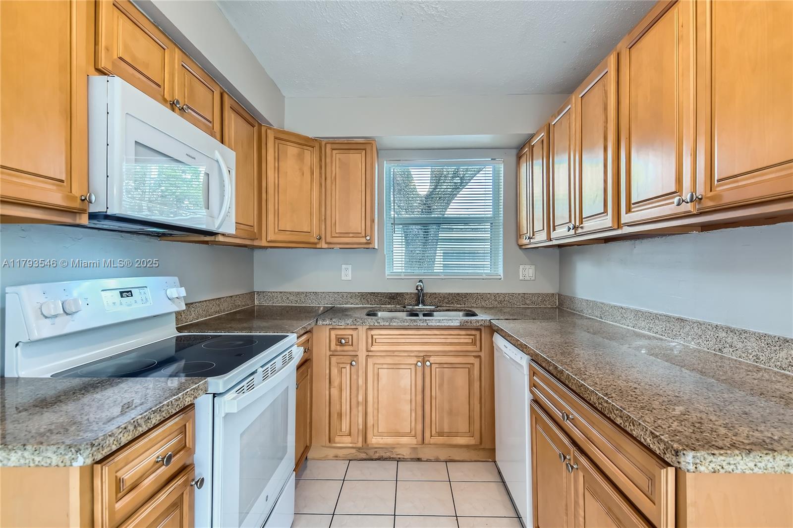 6437 Custer Street Hollywood, FL 33024 - Photo 8 of 22 a kitchen with stainless steel appliances granite countertop a sink stove and cabinets