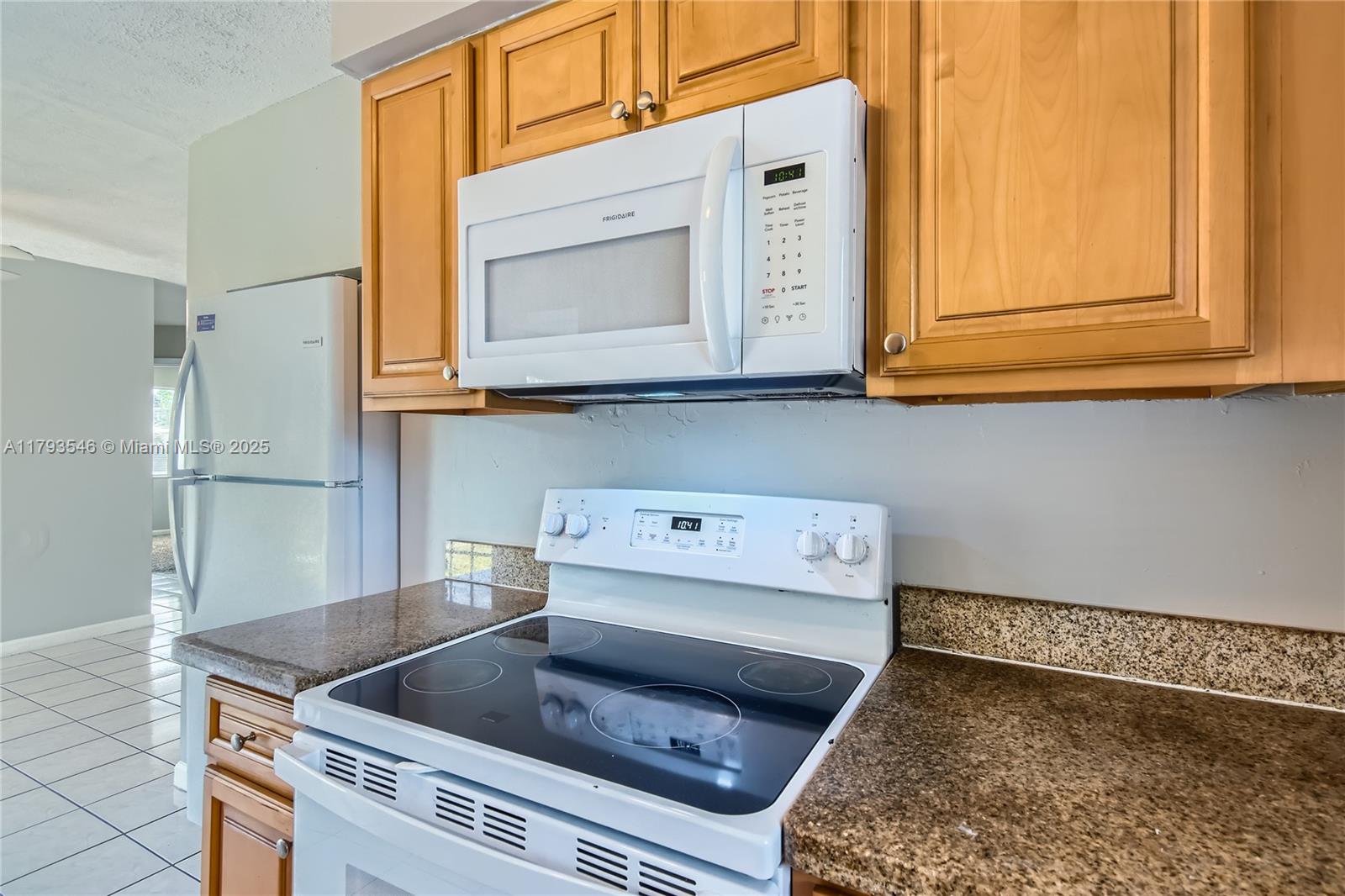 6437 Custer Street Hollywood, FL 33024 - Photo 9 of 22 a kitchen with a stove and a microwave