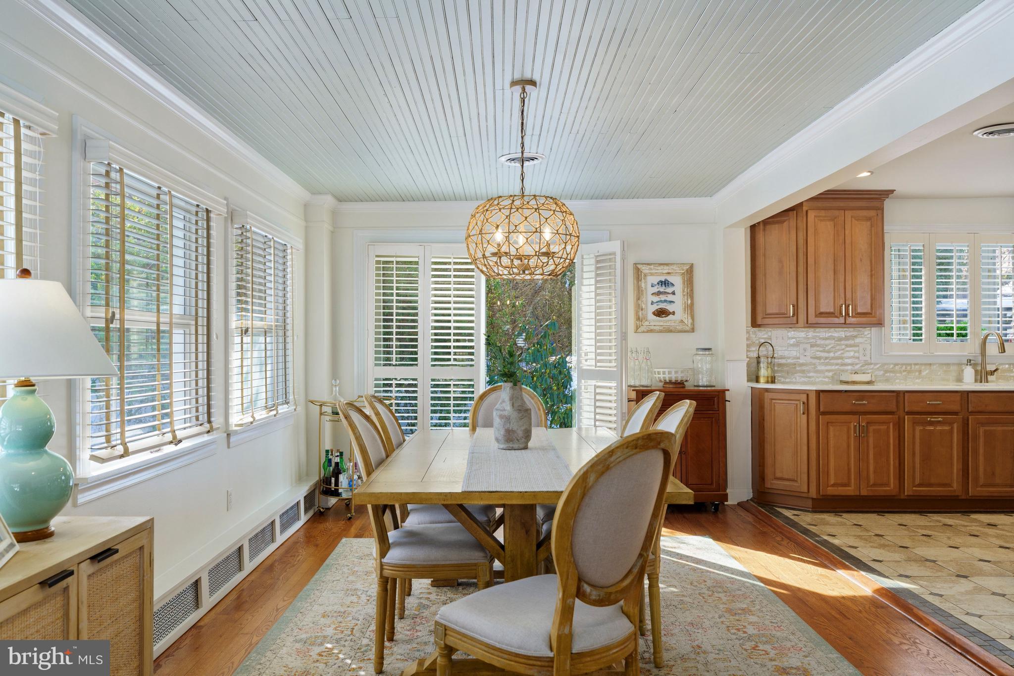 3531 South River Terrace Edgewater, MD 21037 - Photo 11 of 35 a dining room with furniture a chandelier and wooden floor