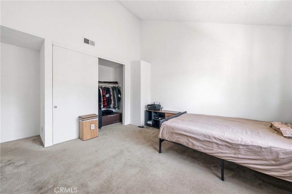 9471 Cortada Street El Monte, CA 91733 - Photo 16 of 27 a bedroom with a bed and a walk in closet