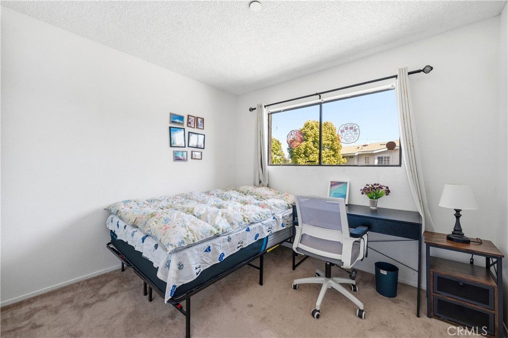 9471 Cortada Street El Monte, CA 91733 - Photo 18 of 27 a bedroom that has a bed and a desk in it