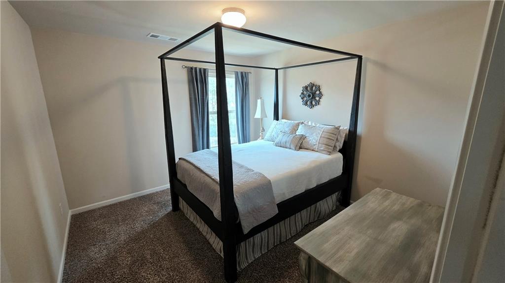 303 High Water Court Acworth, GA 30102 - Photo 17 of 27 a bedroom with a bed and a mirror