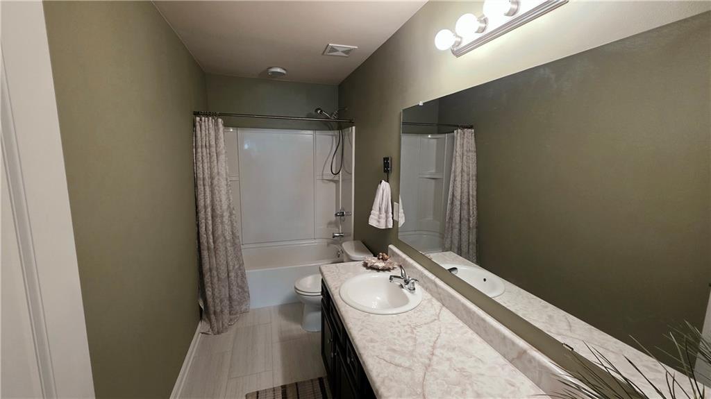 303 High Water Court Acworth, GA 30102 - Photo 19 of 27 a bathroom with a sink a mirror and a toilet