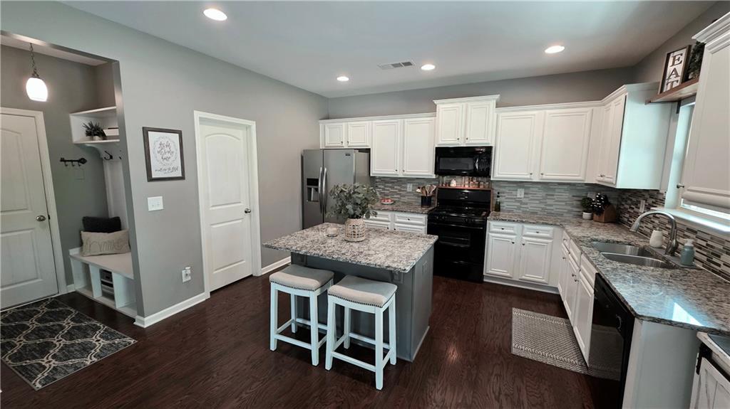 303 High Water Court Acworth, GA 30102 - Photo 5 of 27 a kitchen with a stove a refrigerator and a stove top oven