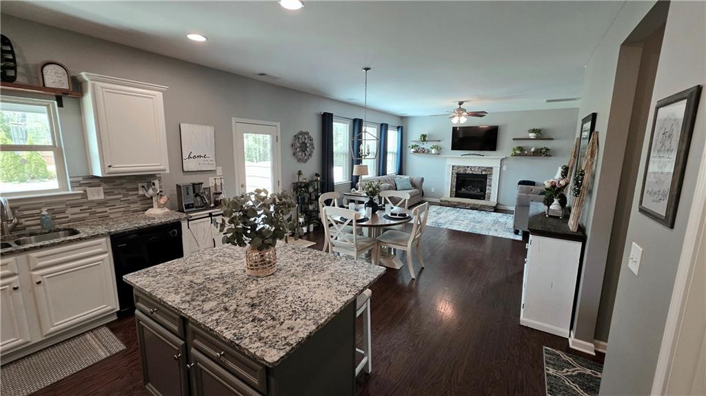 303 High Water Court Acworth, GA 30102 - Photo 7 of 27 a kitchen with stainless steel appliances granite countertop a sink refrigerator stove and microwave