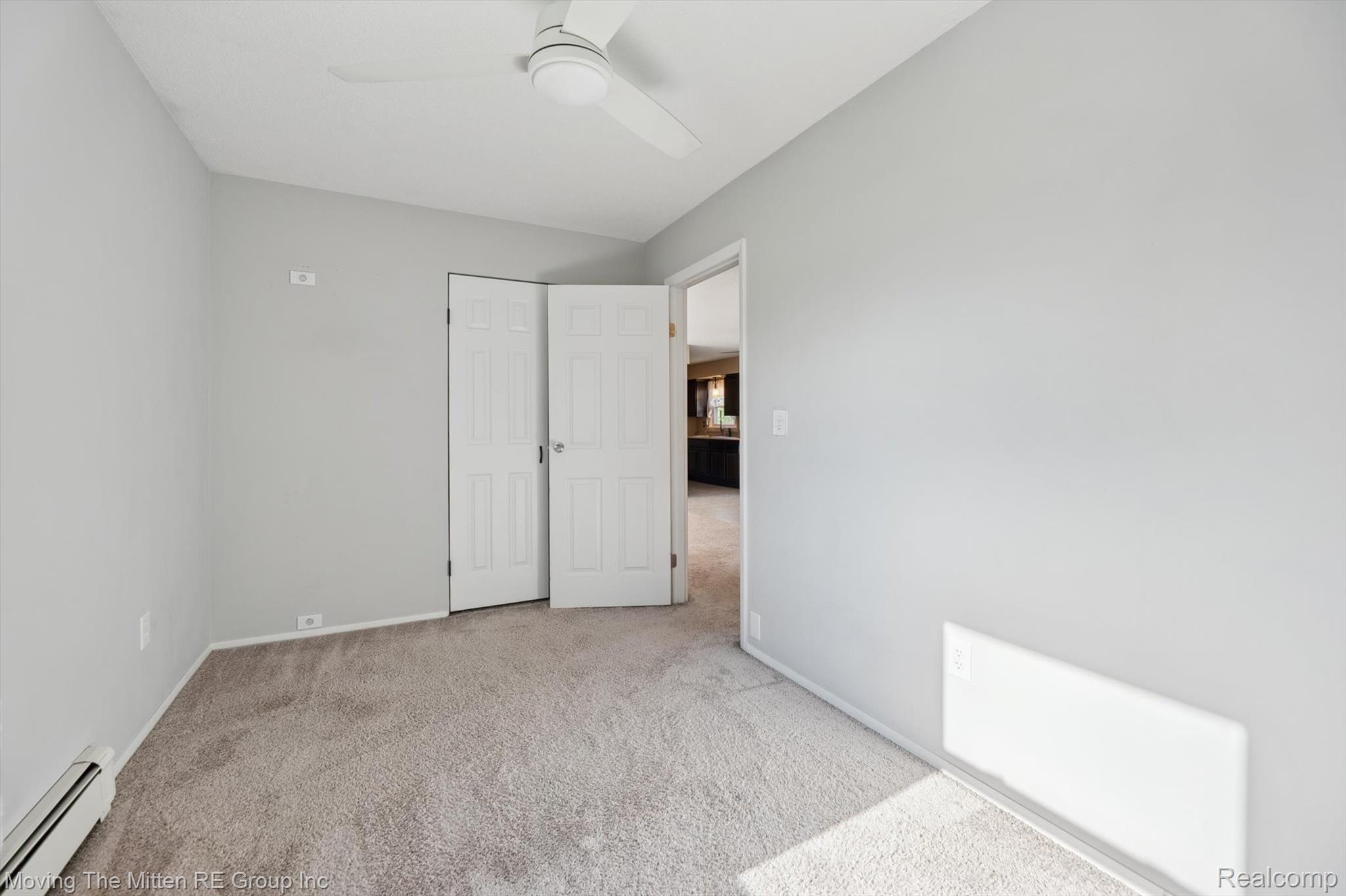 12000 Plank Road Milan, MI 48160 - Photo 25 of 49 Unfurnished bedroom featuring a baseboard radiator, light colored carpet, and ceiling fan