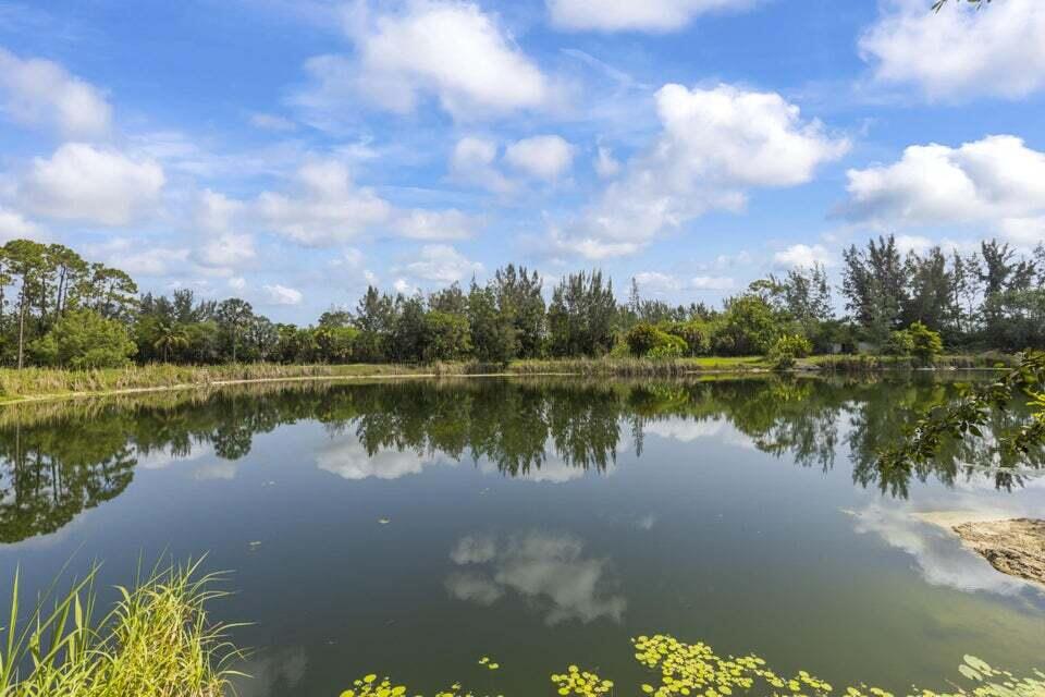 14685 40th Street North Loxahatchee Groves, FL 33470 - Photo 29 of 63 a view of a lake with a city from a lake