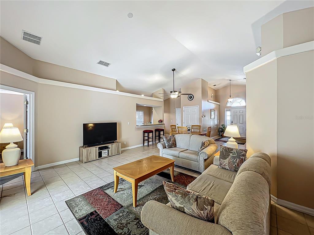 420 Robin Road Davenport, FL 33896 - Photo 11 of 29 a living room with furniture a rug and a flat screen tv