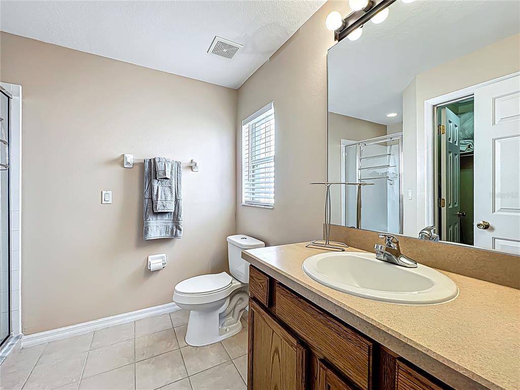 420 Robin Road Davenport, FL 33896 - Photo 17 of 29 a bathroom with a sink toilet and a mirror