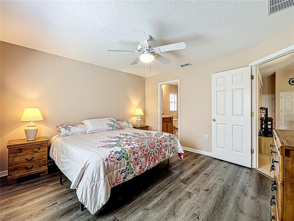 420 Robin Road Davenport, FL 33896 - Photo 18 of 29 a bedroom with a bed and a chandelier
