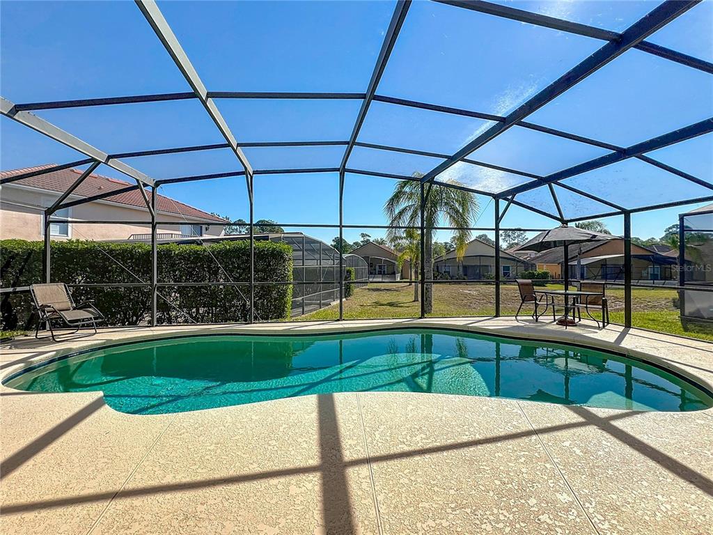 420 Robin Road Davenport, FL 33896 - Photo 2 of 29 a view of a swimming pool with a patio