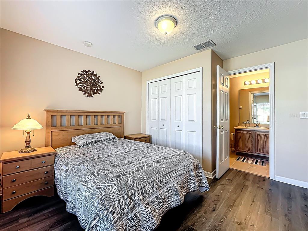 420 Robin Road Davenport, FL 33896 - Photo 22 of 29 a bedroom with a bed and wooden floor