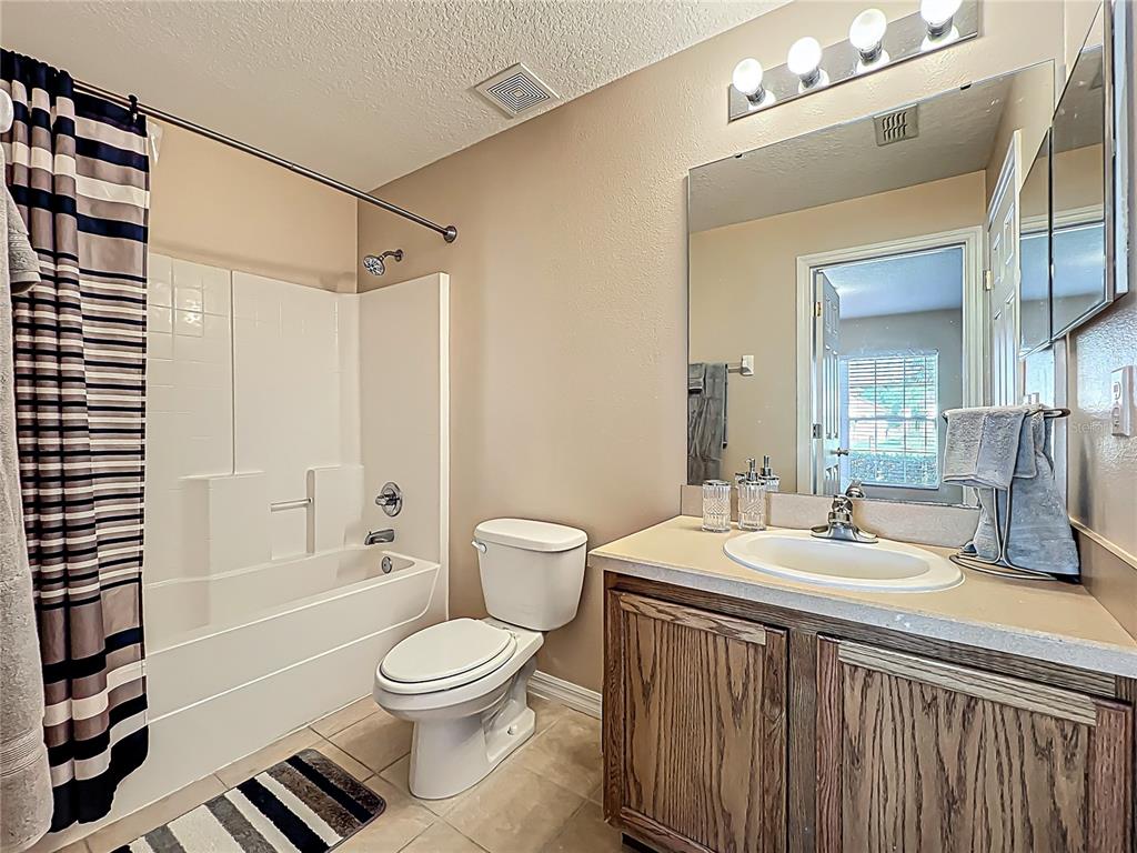 420 Robin Road Davenport, FL 33896 - Photo 23 of 29 a bathroom with a sink a toilet and shower