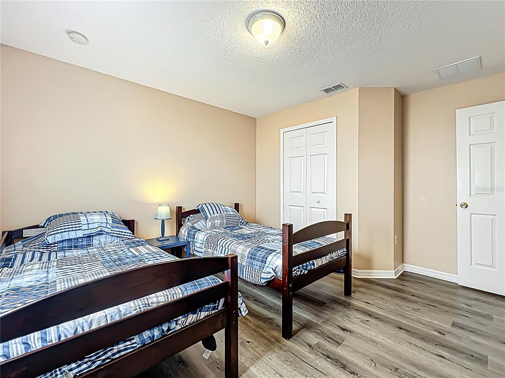 420 Robin Road Davenport, FL 33896 - Photo 25 of 29 a bedroom with furniture and wooden floor