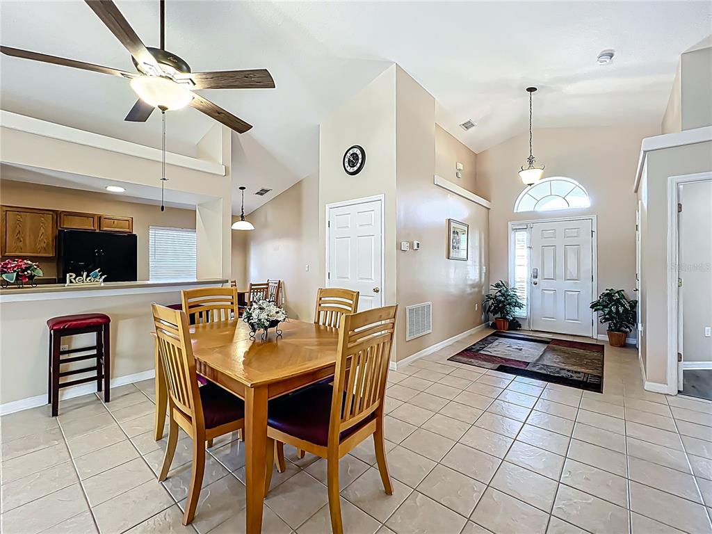 420 Robin Road Davenport, FL 33896 - Photo 8 of 29 a dining room with furniture and a chandelier