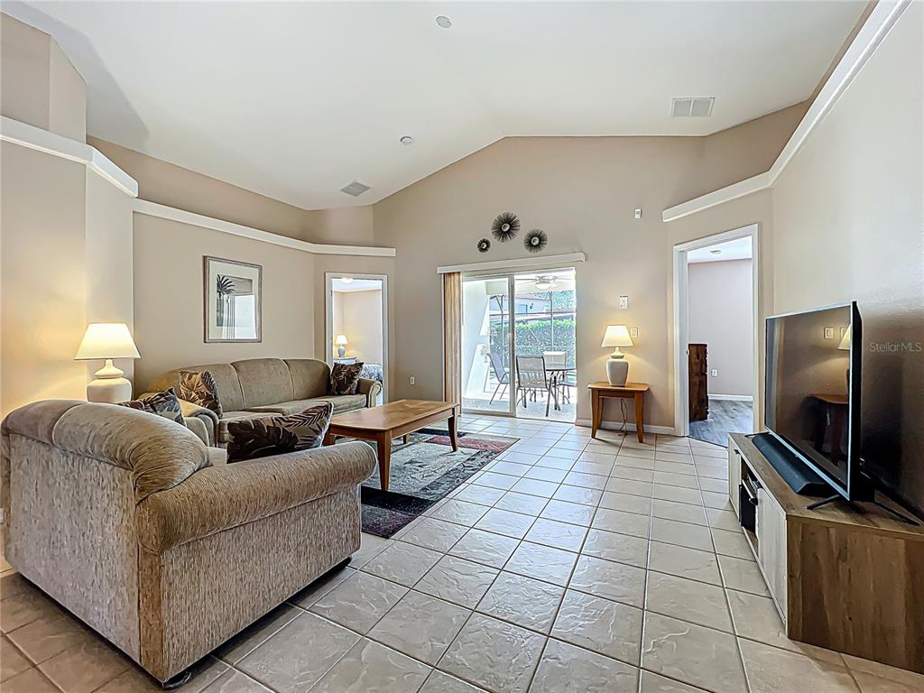 420 Robin Road Davenport, FL 33896 - Photo 9 of 29 a living room with furniture and a flat screen tv