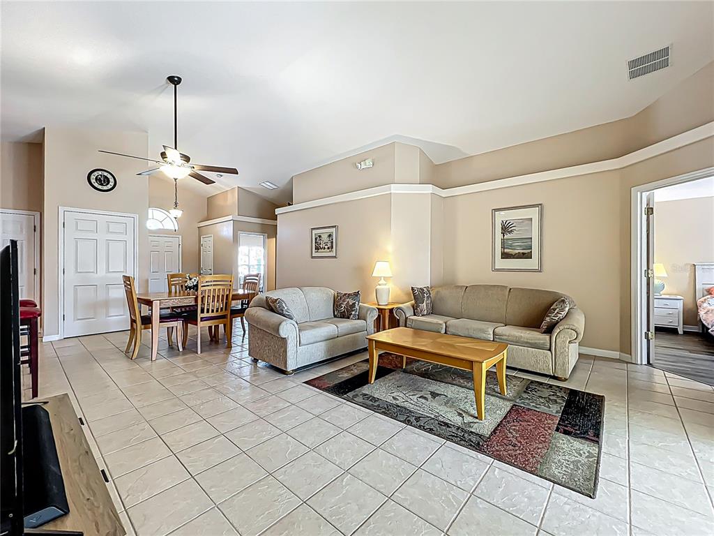 420 Robin Road Davenport, FL 33896 - Photo 10 of 29 a living room with furniture and a chandelier