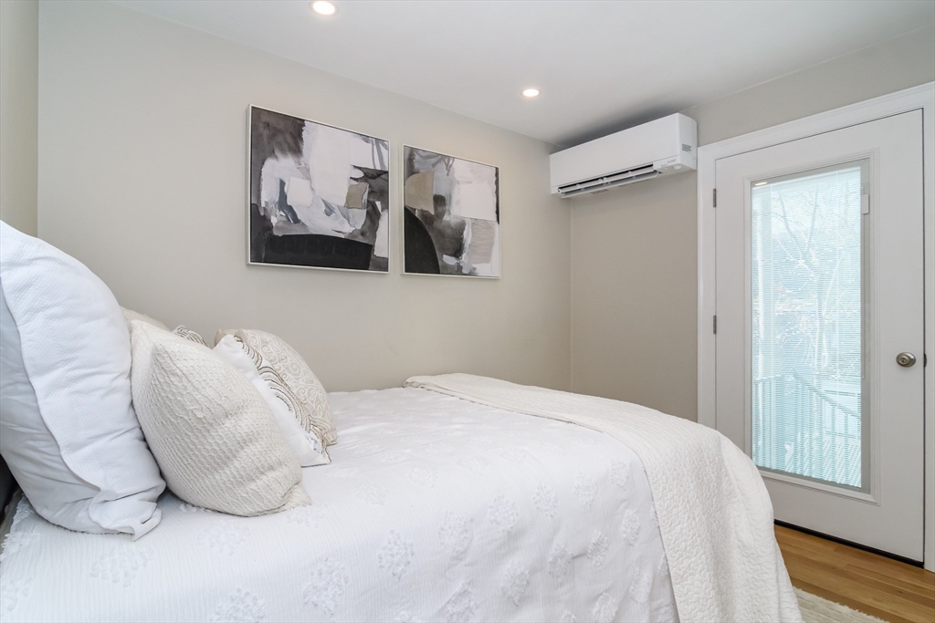 12 R Maugus Avenue, Unit 12R Wellesley, MA 02481 - Photo 11 of 19 a bedroom with a bed and a painting on the wall