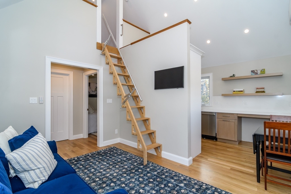 12 R Maugus Avenue, Unit 12R Wellesley, MA 02481 - Photo 5 of 19 a living room with furniture and a flat screen tv